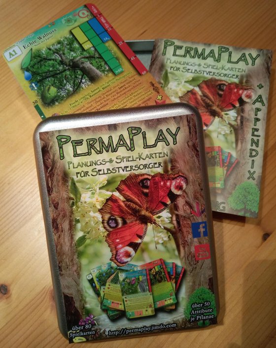 Permaplay from 2018 in its metal tin, with the walnut card and the companion booklet